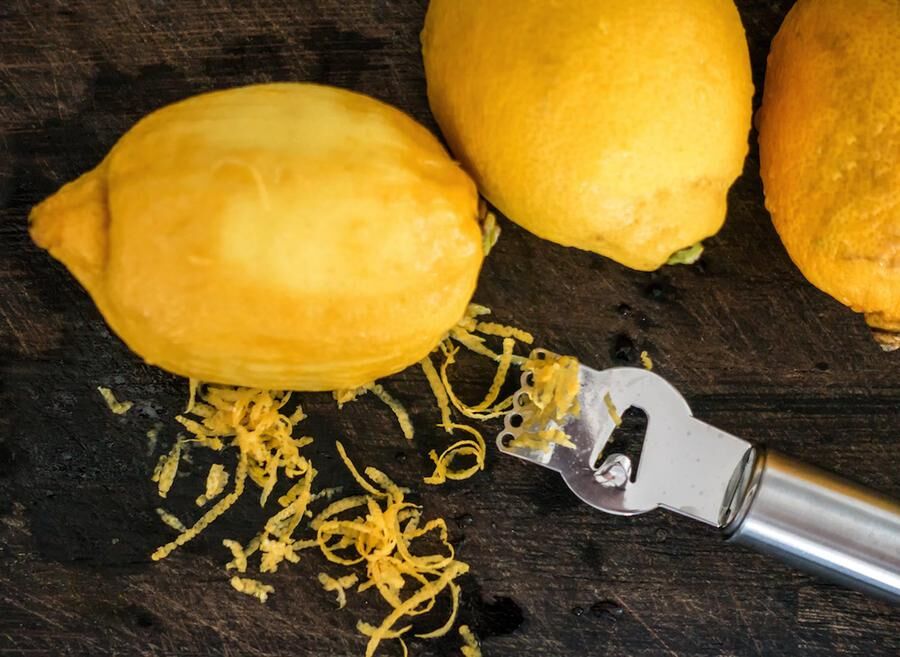 Peeling lemon rind to add zest to cook