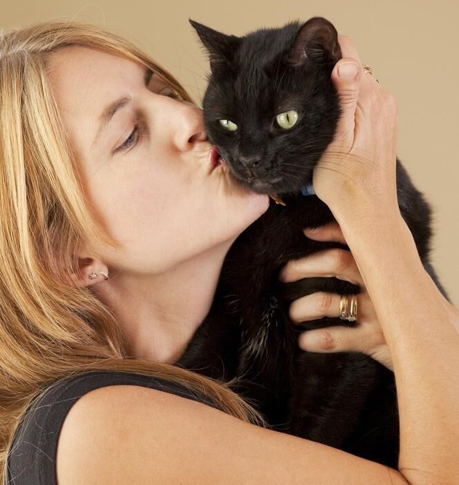 Woman Kissing Black Cat