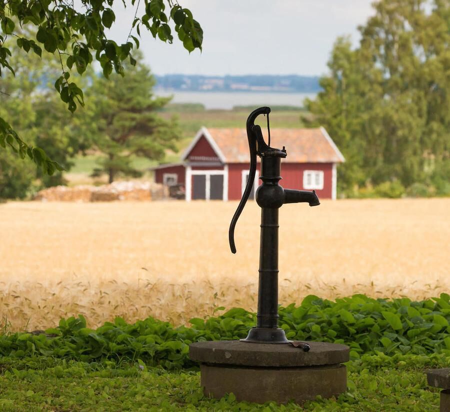 VADSTENA SWEDEN 26 July 2016. A typical old water pump on the country which probably is not used anymore,